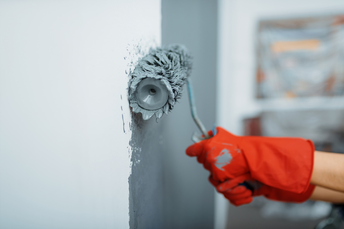 Female House Painter Hand with Paint Roller